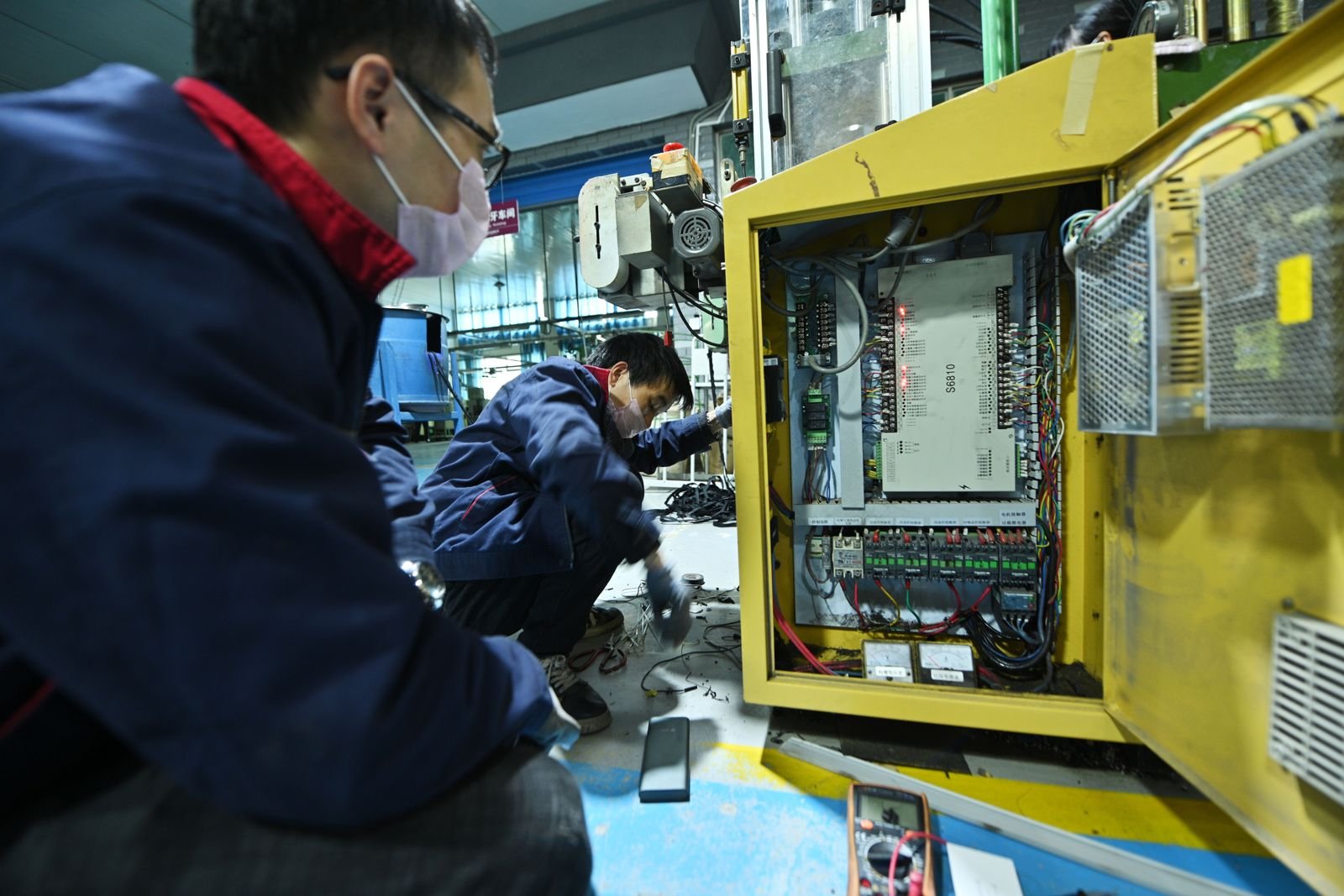 QC technician inspecting a finished zipper at VQV factory